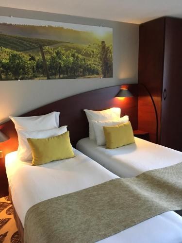 Postel nebo postele na pokoji v ubytování Contact Hôtel Le Provençal Bordeaux Lac