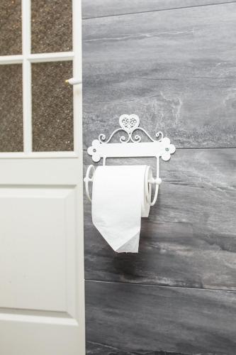 a roll of toilet paper hanging from a door at Paju Apartement with Sauna in Võru