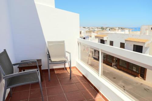 a balcony with two chairs and a desk on a building at Boa Vista Hotel & Spa - Adults Only in Albufeira