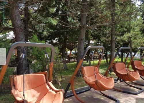 a row of empty swings in a park at Ana's Apartment in Chakvi Oasis in Chakvi