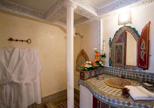 a bathroom with a sink and a mirror at Riad Fes Kettani in Fez