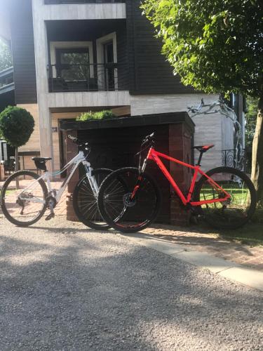two bikes are parked next to a building at Vila 6aTo Hotel & Wellnes in Sofia