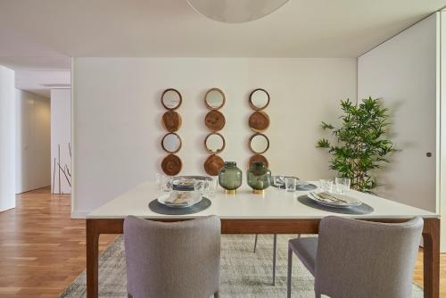 a dining room with a table with mirrors on the wall at Luxury Apartment in the most privileged Lisbon in Lisbon