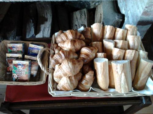 a tray of bread and pastries on a table at Auberge du Gros Tilleul in Argoules