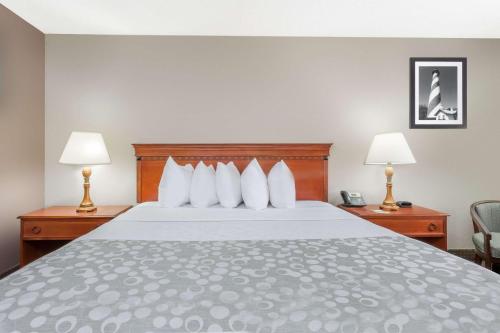 a bed in a hotel room with two lamps at Days Inn by Wyndham St Augustine/Historic Downtown in Saint Augustine