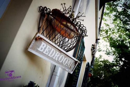 a sign for a bakery on the side of a building at B&B A Casa di Mael in San Costanzo