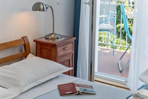 a bedroom with a bed and a lamp on a table at Beachfront Apartment Mala Tereza in Split