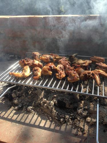 a bunch of chicken cooking on a grill at Locanda Marzi in Faicchio