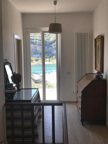 a living room with a large window and a table at Relais Santa Caterina in Portovenere