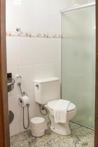 a bathroom with a toilet and a shower stall at Gamboa Eco Refugio Pousada in Iporanga
