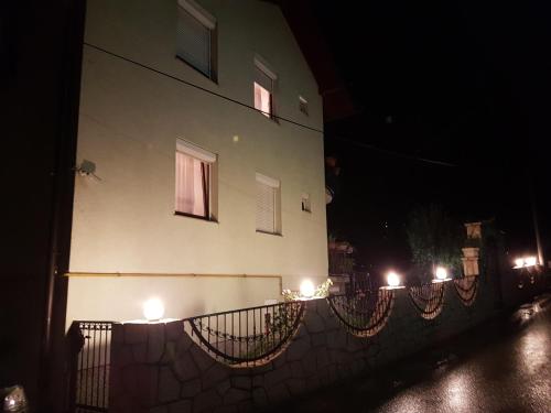 a building with lights on the side of it at night at Guest house Dinka in Sarajevo