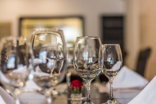 a row of wine glasses sitting on a table at Wayqey Hotel in Cusco