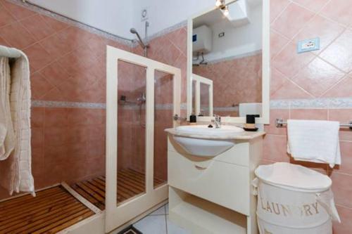 a bathroom with a sink and a shower and a toilet at Holiday ApartHotel in Santa Maria