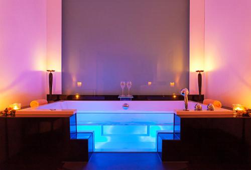 a bath tub with blue and purple lights in a room at Romantik Hotel Johanniter-Kreuz in Überlingen