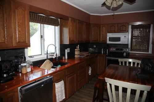 a kitchen with wooden cabinets and a wooden counter top at Charming Home Near Ski Areas in Rumford