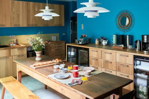 a kitchen with a wooden table with food on it at Eden Lodge Paris in Paris