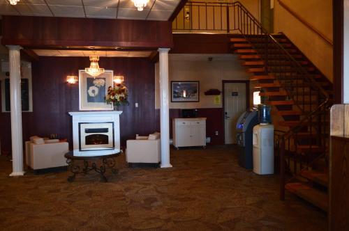 a living room with a staircase and a stair case at Hotel Port Aux Basques in Channel-Port aux Basques