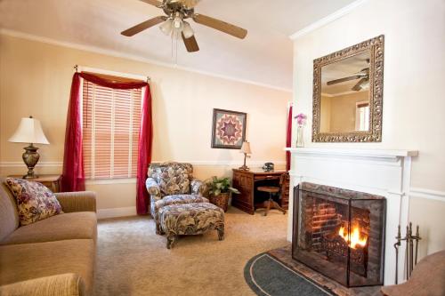 a living room with a fireplace and a mirror at St. Francis Inn - Saint Augustine in Saint Augustine