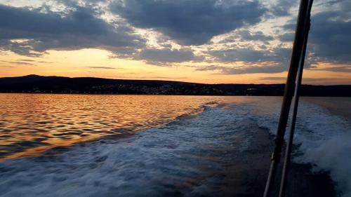 a boat on a lake at sunset at Mali Šjor in Primošten