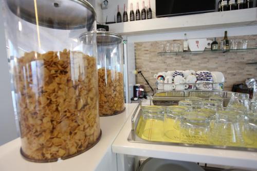 a kitchen counter with a blender filled with food at Hotel Eubea in Reggio Calabria