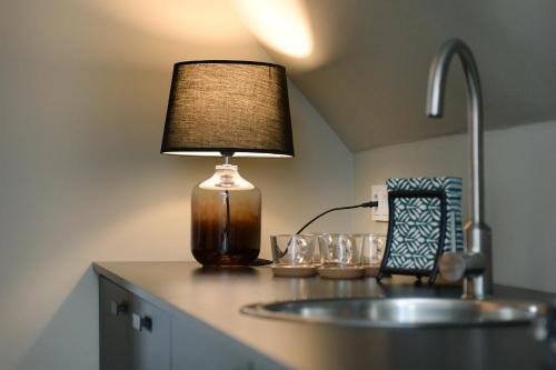 una lámpara sentada en un mostrador junto a un fregadero en Messeapartment Sunny Side, en Düsseldorf