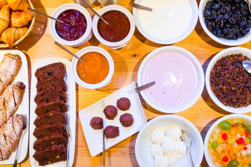 a table topped with different types of food in bowls at Penzion Berc in Bled