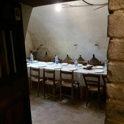 a table with chairs and bottles of water on it at B&B Casa Zia Cianetta Residenza di Campagna in Capodacqua di Foligno