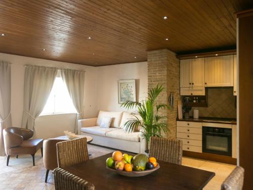 a living room with a table with a bowl of fruit at Carvoeiro Beach Duplex in Carvoeiro