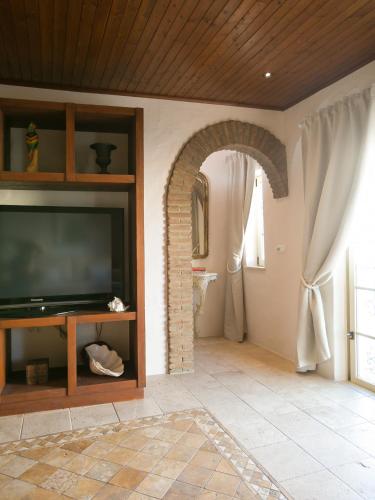 a living room with a flat screen tv on a wall at Carvoeiro Beach Duplex in Carvoeiro