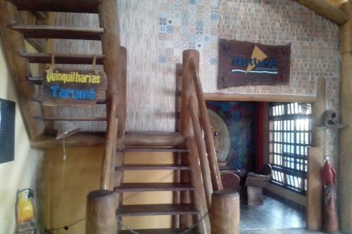 a room with a wooden staircase in a house at Pousada Taruma in Mucuri