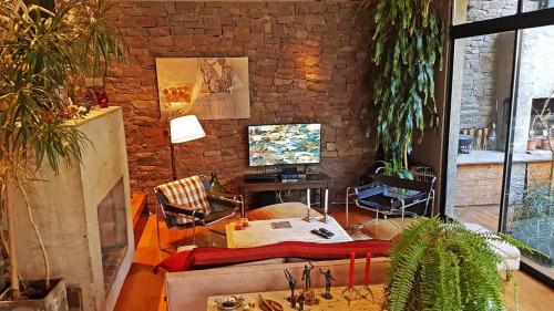 sala de estar con sofá y pared de ladrillo en Luxury house jacuzzi & garden - rental in Mendoza en Mendoza