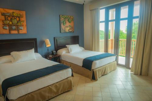 Postel nebo postele na pokoji v ubytování Hotel Presidente Las Tablas