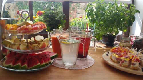 a table with two plates of food and drinks at Dom Przy Plaży in Sarbinowo