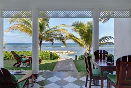 a dining room with a table and a view of the ocean at Half Moon in Montego Bay