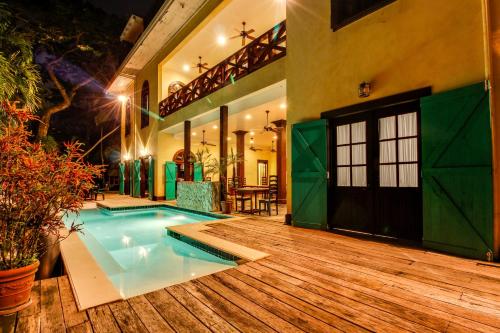 a house with a swimming pool in a yard at Colonial Suite @ Mahogany Hall in San Ignacio