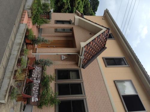 an external view of a building with a balcony at Beppu Yukemuri-no-oka Youth Hostel in Beppu