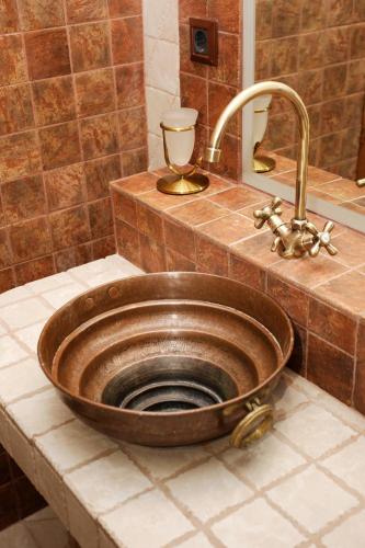 a bathroom sink with a copper bowl in it at DIMITRA's VILLAS in Elatochori