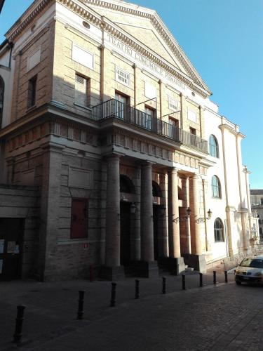 a large brick building with a balcony on a street at Albergo Roma in Lanciano