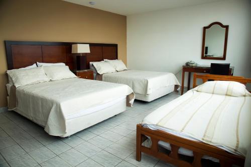 Una cama o camas en una habitación de Hotel República Panamá