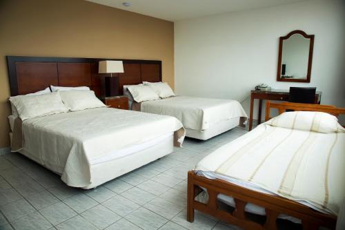Postel nebo postele na pokoji v ubytování Hotel República Panamá
