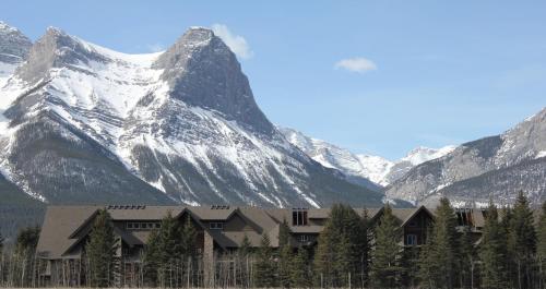 a building in front of a snow covered mountain at Paradise Resort Club and Spa in Canmore