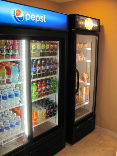 an open refrigerator with soda and drinks in it at Cobblestone Inn & Suites - Ambridge in Ambridge