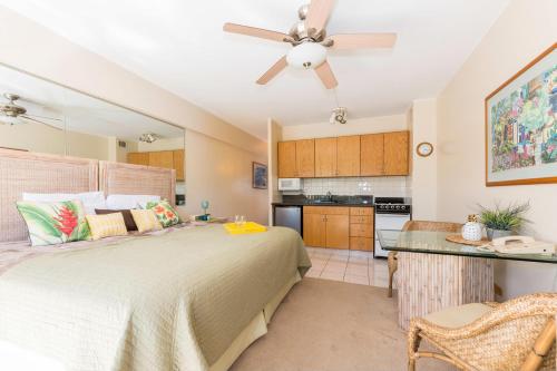 a bedroom with a bed and a ceiling fan at Waikiki Shore 305 (beachfront/balcony) in Honolulu