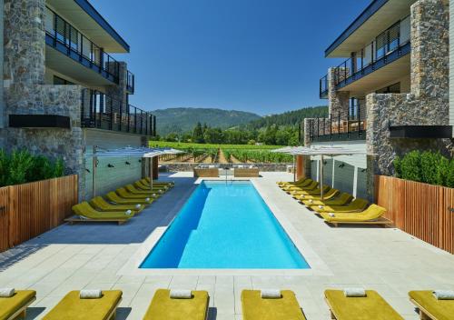 an outdoor pool with lounge chairs and a resort at Alila Napa Valley, a Hyatt Resort in St. Helena