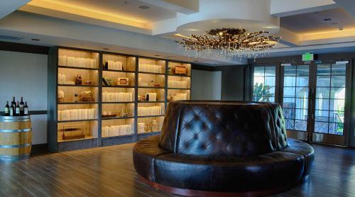 a leather chair in a room with a wine cellar at River Terrace Inn, a Noble House Hotel in Napa