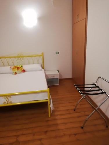 a bedroom with a bed and two chairs in it at Residenza Skanderbeg in Montecilfone