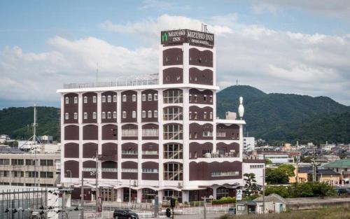a large building with a clock tower on top of it at Mizuho Inn Iwami Masuda in Masuda
