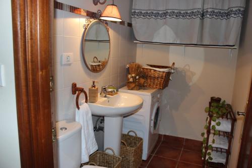 a small bathroom with a sink and a mirror at Amets etxalde in Santecilla