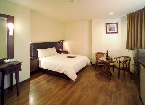 מיטה או מיטות בחדר ב-Hua Tai Hotel