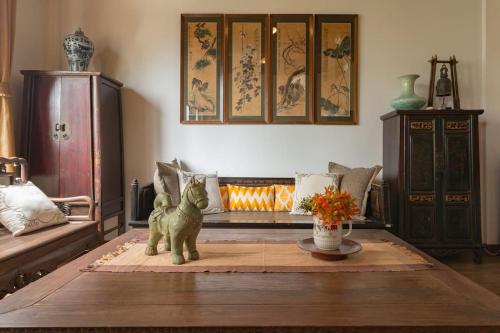 a living room with a fireplace and a cat statue at Artisan's Antique House - Silom in Bangkok